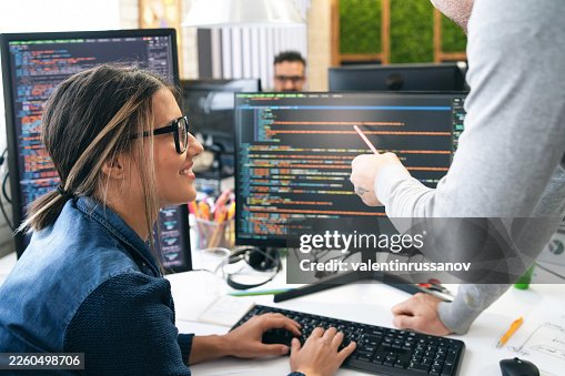 Software engineers collaborating on programming code and web development Software engineers collaborating on programming code and web development