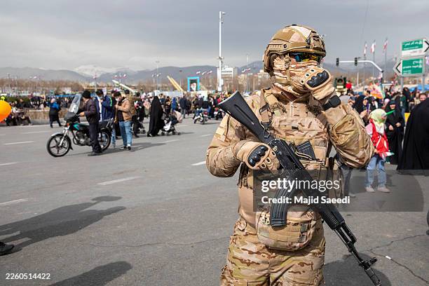 An Iranian special forces soldier stands guard during commemorations to mark the anniversary of the 1979 Iranian Revolution on February 11, 2026 in...