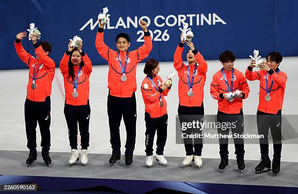 Silver medalists of Team Japan celebrate on the podium during the Medal Ceremony for the Team Event following the Men's Single Skating - Free Skating...