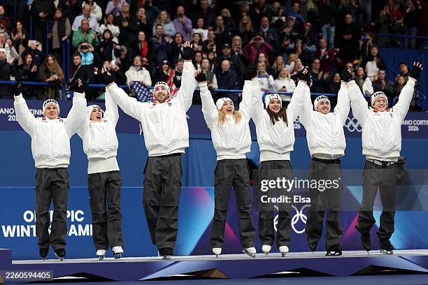 Bronze medalist Team Italy acknowledges the crowd on the podium during the Medal Ceremony for the Team Event following the Men's Single Skating -...