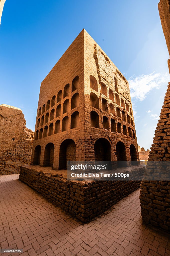 Ancient mud-brick architecture under a clear blue sky, showcasing historical design and texture,Turpan,China,Gaochang District