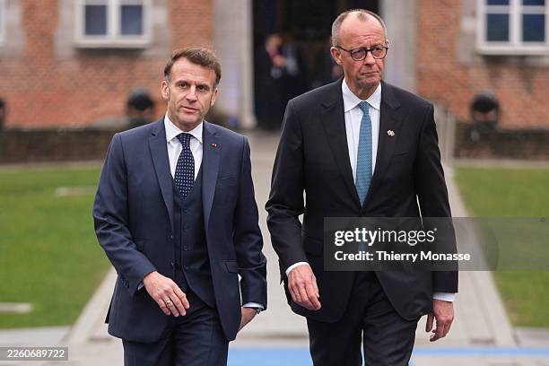 French President Emmanuel Macron and the German Chancellor Friedrich Merz arrive for an EU Informal Summit in the Alden Biesen Castle on February 12,...