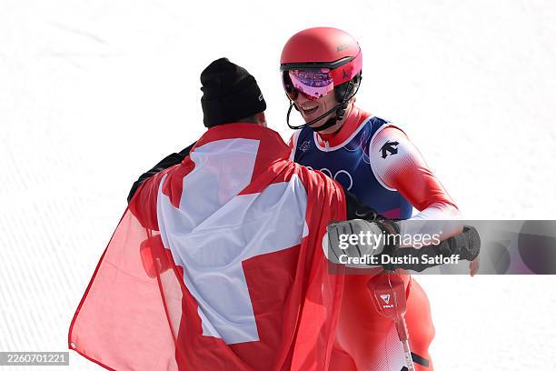 Tanguy Nef of Team Switzerland celebrates with his teammate Franjo von Allmen at the finish line during the Men's Team Combined Slalom on day three...