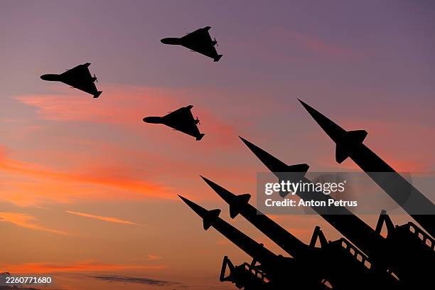 missile system and kamikaze drones at sunset sky - missile stock pictures, royalty-free photos & images