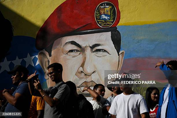 Mural depicting former Venezuelan president Hugo Chavez is seen during a march by government supporters on International Youth Day in Caracas on...