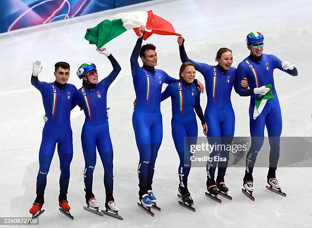 Members of Team Italy celebrate after winning gold in the Short Track Speed Skating Mixed Team Relay finals on day four of the Milano Cortina 2026...