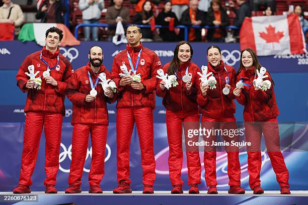 Silver medalists Kim Boutin, Courtney Sarault, William Dandjinou and Felix Roussel of Team Canada pose for a photo on the podium during the medal...