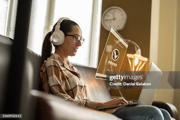 woman managing online security system, interacts with virtual interface - security patch stock pictures, royalty-free photos & images