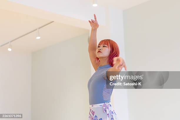 young female ballet dancer dancing in ballet studio - low angle view - dance practice stock pictures, royalty-free photos & images