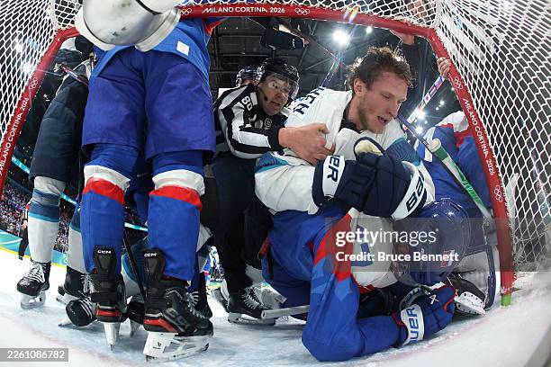 Eetu Luostarinen of Team Finland and Simon Nemec of Team Slovakia scuffle in the first period during the Men's Preliminary Group B match between...