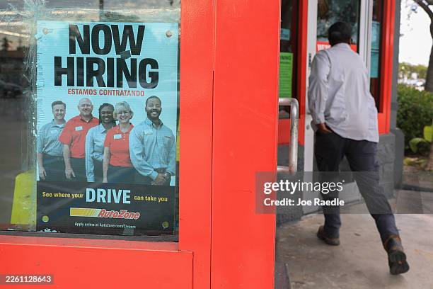 Now Hiring" sign is seen at an AutoZone on February 11, 2026 in Hollywood, Florida. The US economy added an estimated 130,000 jobs last month, and...