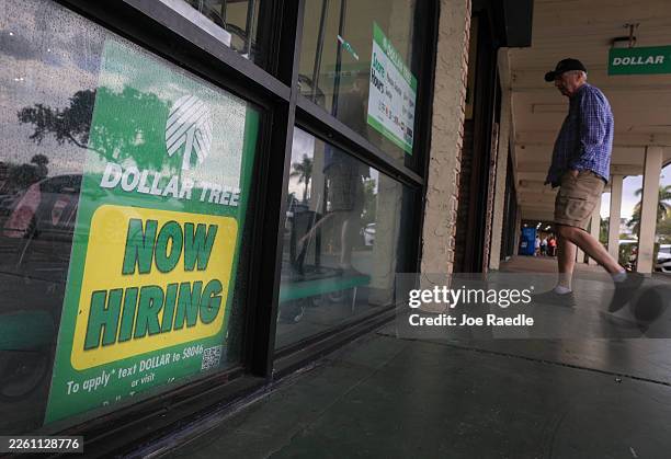 Now Hiring" sign is seen at a Dollar Tree store on February 11, 2026 in Hollywood, Florida. The US economy added an estimated 130,000 jobs last...