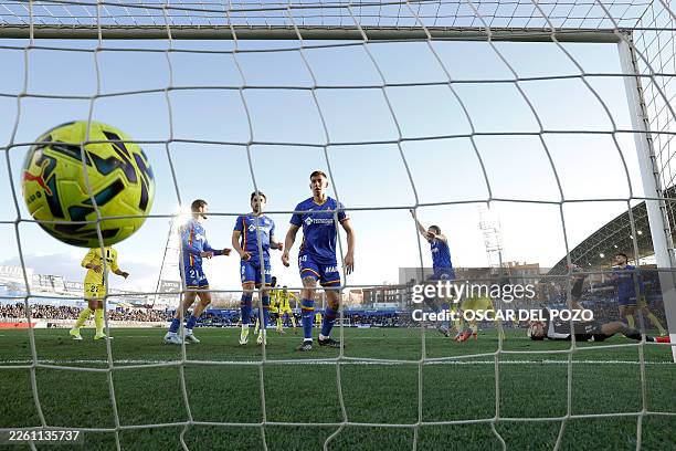 Getafe's Spanish goalkeeper David Soria gets injured as Villarreal's French forward Georges Mikautadze scores a goal during the Spanish league...