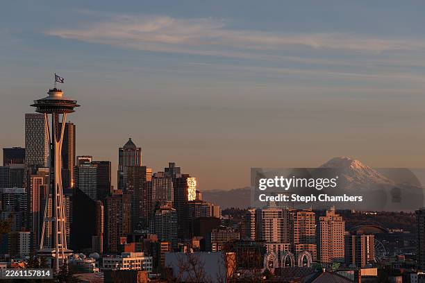 Flag wave on top of the Space Needle in front of Mount Rainier after the Seattle Seahawks Super Bowl LX victory celebration and parade on February...