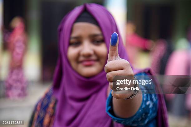 Woman shows proof of voting at the Gaibandha Government College center since morning to cast their votes in the election on February 12, 2026 in...