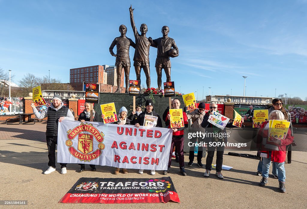 Placards For Rally Protesters hold a banner and placards during the rally in front of ...