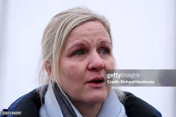 President Kirsty Coventry cries as she speaks to the media after Vladyslav Heraskevych of Team Ukraine was disqualified from competition in the Men's...