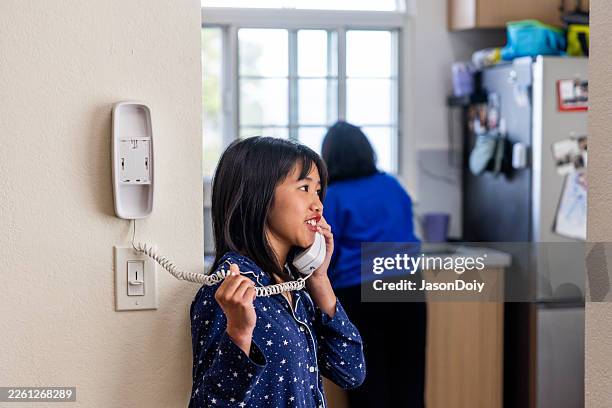 teen girl using a landline telephone - landline phone stock pictures, royalty-free photos & images