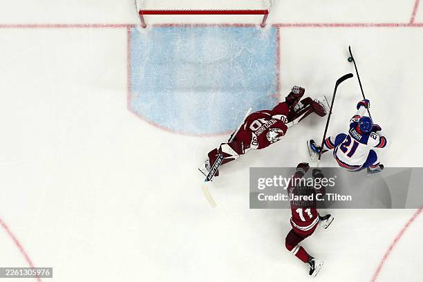 Dylan Larkin of Team United States attempts to shoot the puck against Elvis Merzlikins and Dans Locmelis of Team Latvia in the first period during...