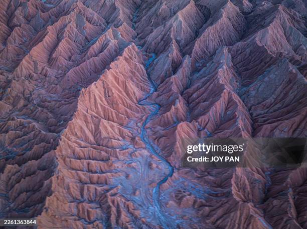aerial view of red desert badlands with winding dry riverbed - mountain ridge stock pictures, royalty-free photos & images