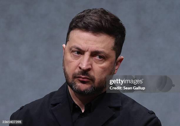 Ukrainian President Volodymyr Zelensky listens to a journalist's question while visiting the production facility of Quantum Frontline Industries on...