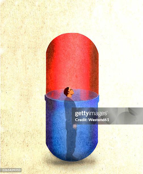 human figure standing inside a large blue and red medicine capsule - drug abuse stock illustrations
