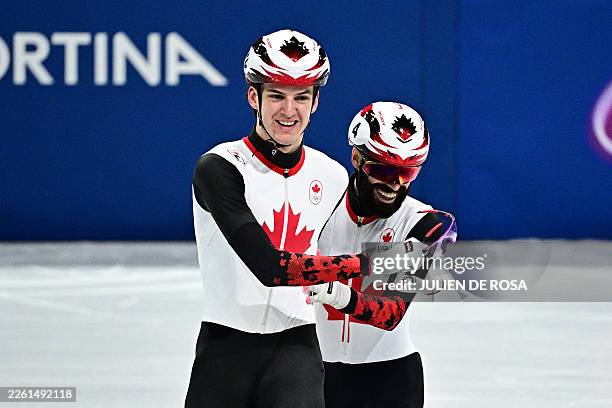 Canada's Felix Roussel and Steven Dubois react after qualifying to the final in the short track speed skating men's 5000m relay semi-final during the...