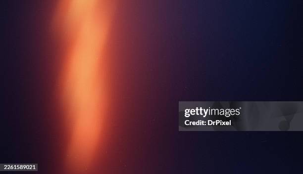 warm orange light leak on dark gradient background - efeito de luz imagens e fotografias de stock