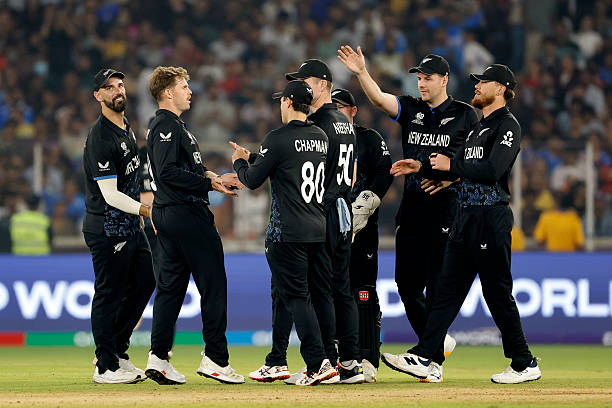 Lockie Ferguson of New Zealand celebrates with teammates after taking the wicket of Quinton de Kock of South Africa during the ICC Men's T20 World...