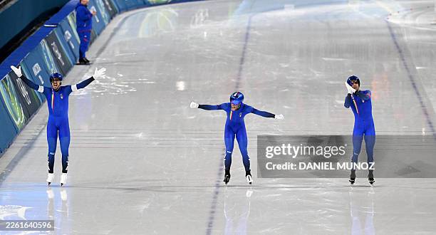 Italy's Davide Ghiotto, Italy's Michele Malfatti and Italy's Andrea Giovannini celebrate after crossing the finish line to win gold in the speed...