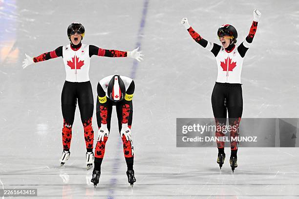 Canada's Valerie Maltais, Canada's Isabelle Weidemann and Canada's Ivanie Blondin celebrate as they cross the finish line to win gold in the speed...