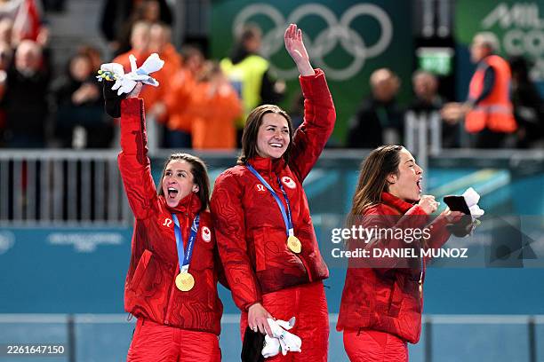 Gold medallists Canada's Valerie Maltais, Canada's Isabelle Weidemann and Canada's Ivanie Blondin pose on the podium of the speed skating women's...