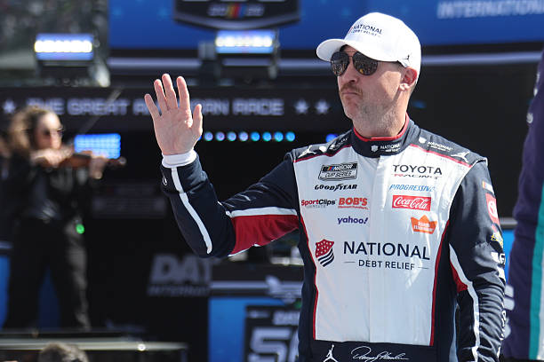 Denny Hamlin waves to the crowd prior to the running of the 68th NASCAR Cup Series Daytona 500 on February 15, 2026 at Daytona International Speedway...