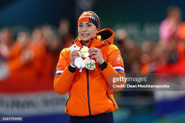 Gold medalist Femke Kok of Team Netherlands celebrates on the podium during the medal ceremony for the Speed Skating Women's 500m on day nine of the...