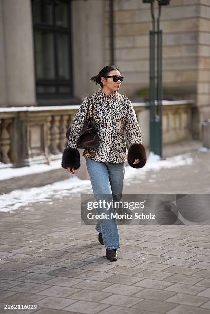 Milena Karl is seen wearing a cream and black leopard print "dolly" faux fur jacket with a classic collar, front leather button closure and dark...