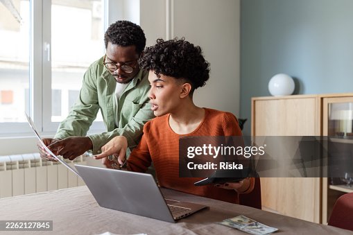 Young partners organizing household expenses together Young partners organizing household expenses together