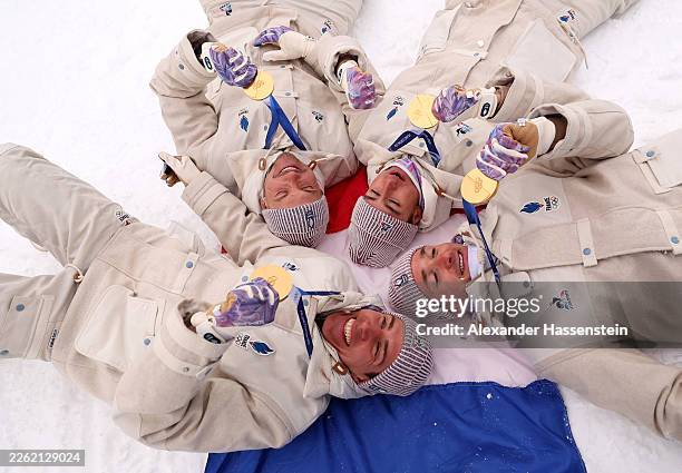 Gold medalists Fabien Claude, Emilien Jacquelin, Quentin Fillon Maillet and Eric Perrot of Team France celebrate after the medal ceremony for the...