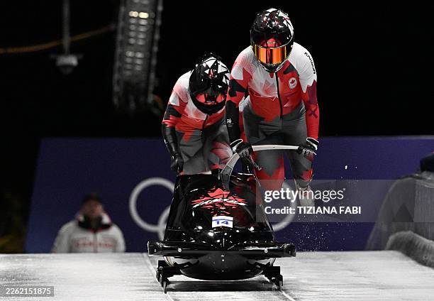 Canada's Melissa Lotholz and Canada's Kelsey Mitchell compete in the women's bobsleigh 2-woman heat 2 at Cortina Sliding Centre during the Milano...
