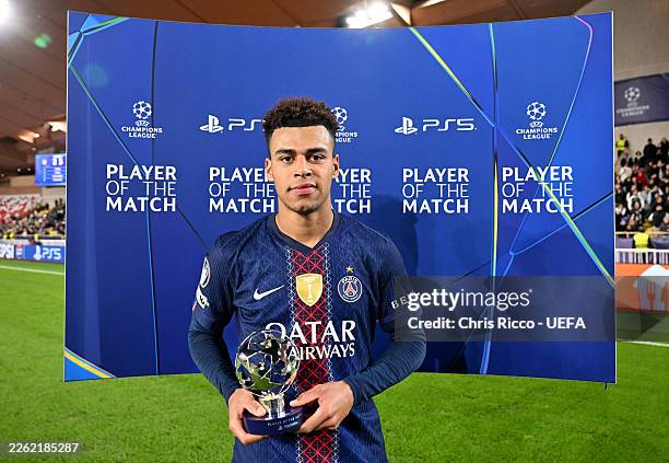 Desire Doue of Paris Saint-Germain poses for a photo with the PlayStation Player Of The Match award after the team's victory during the UEFA...