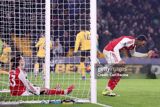 Riccardo Calafiori and Gabriel of Arsenal look dejected after Tom Edozie of Wolverhampton Wanderers scores his team's second goal during the Premier...