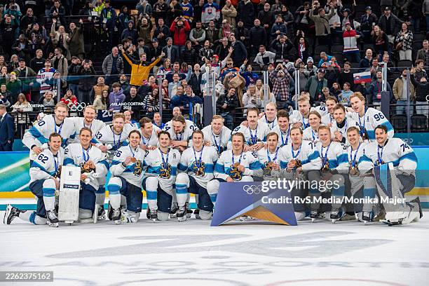 Team Finland pose for photo with their bronze medals after the Men's Bronze Medal match between Slovakia and Finland on day fifteen of the Milano...