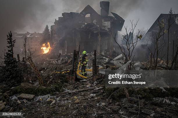 First responders work at the site of a Russian attack on February 22, 2026 in the Sofiivska Borshchahivka suburb of Kyiv, Ukraine. Missile and drone...