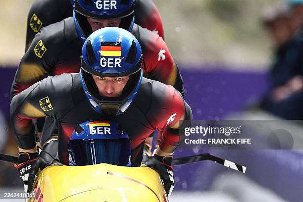 Germany's Georg Fleischhauer, Germany's Johannes Lochner, Germany's Jorn Wenzel and Germany's Thorsten Margis take the start in the bobsleigh men's...