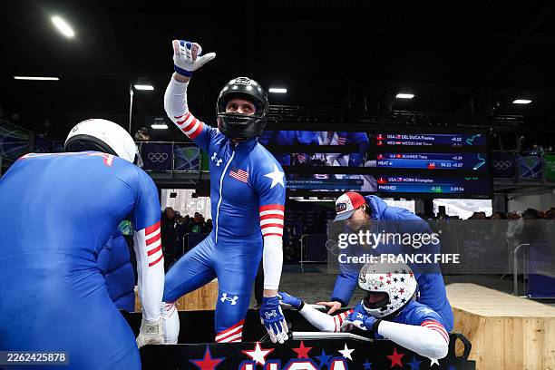 S Kristopher Horn, USA's Caleb Furnell, USA's Hunter Powell and USA's Carsten Vissering react after crossing the finish line in the bobsleigh men's...
