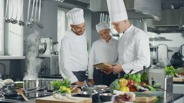 https://media.gettyimages.com/id/2262450977/video/three-chefs-collaborate-in-a-modern-kitchen-using-a-digital-tablet-to-browse-online-menus-and.jpg?b=1&s=640x640&k=20&c=yXxzQHZZT2qesofg9a8rHKtYavT7kj_VOf3NfeNfPzE=