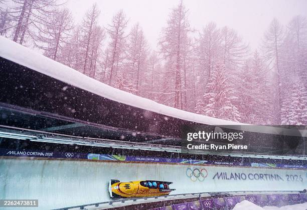 Adam Ammour of Team Germany pilots his team as they participate in heat four of the 4-man Bobsleigh training on day thirteen of the Milano Cortina...
