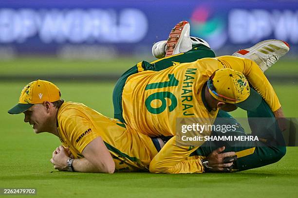 South Africa's Corbin Bosch collides with teammate Keshav Maharaj after taking a catch to dismiss India's Abhishek Sharma during the 2026 ICC Men's...