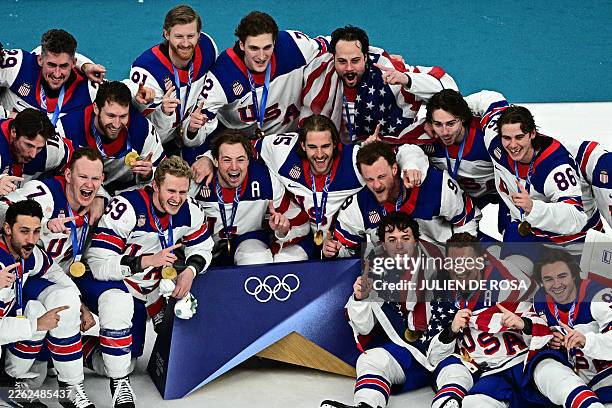 Gold medallists USA's players celebrate during the medals ceremony of the men's ice hockey event at the Milano Santagiulia Ice Hockey Arena during...