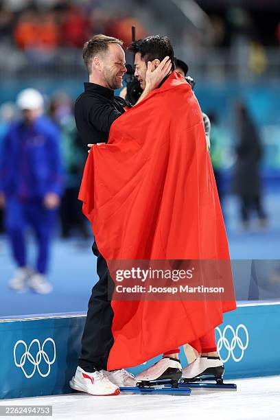 Gold medalist Zhongyan Ning of Team People's Republic of China celebrates with his coach after competing in the Speed Skating Men's 1500m on day...