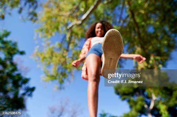 woman stepping forward with shoe sole visible from low angle - sole of shoe stock pictures, royalty-free photos & images